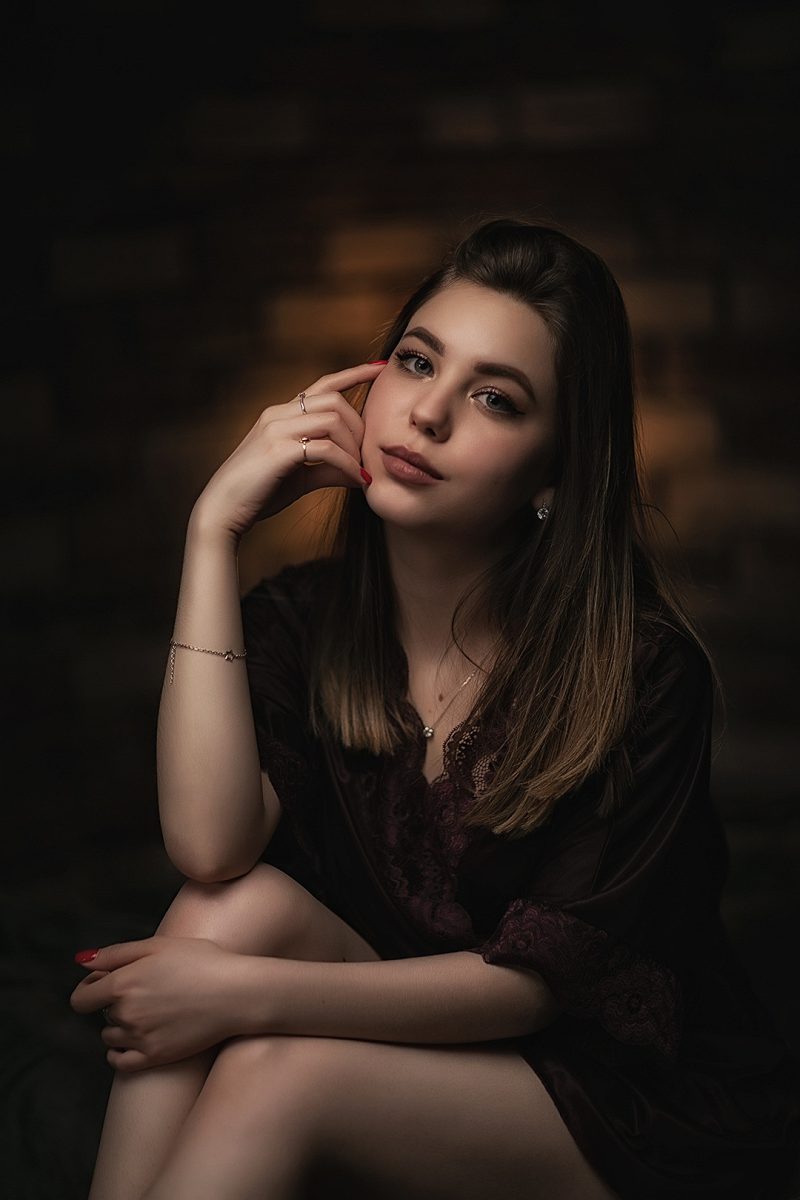 Studio portrait of a woman in a dark lace blouse