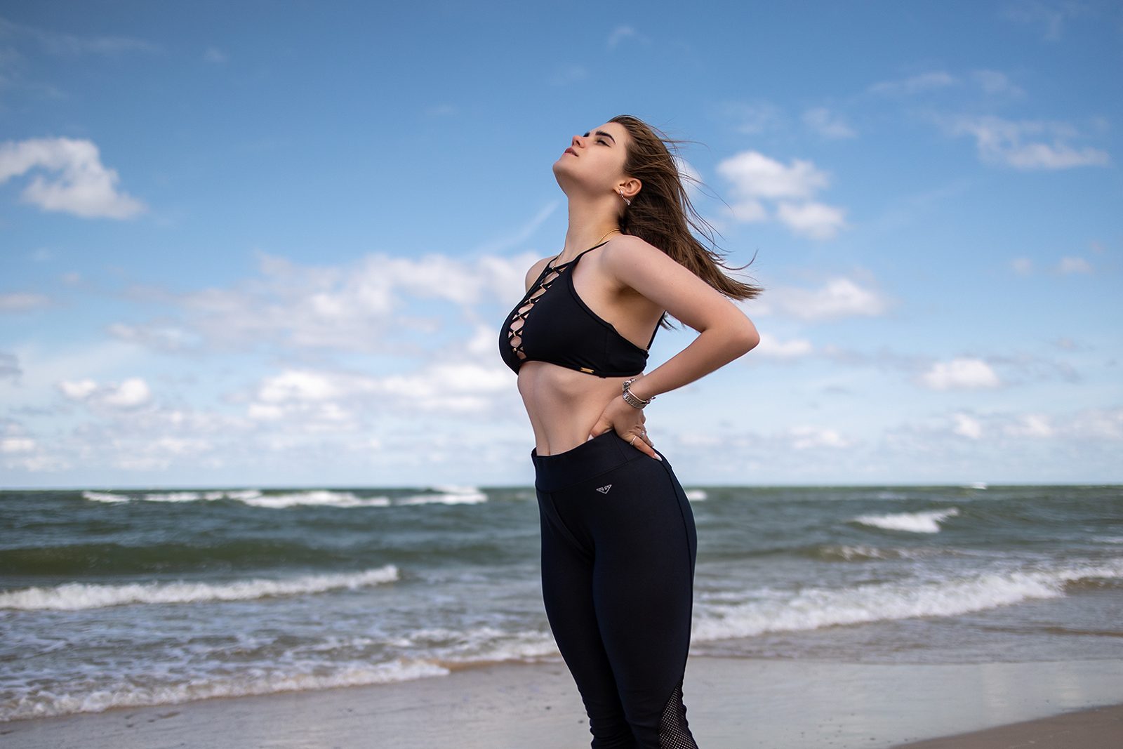Woman in a black top standing on the seashore